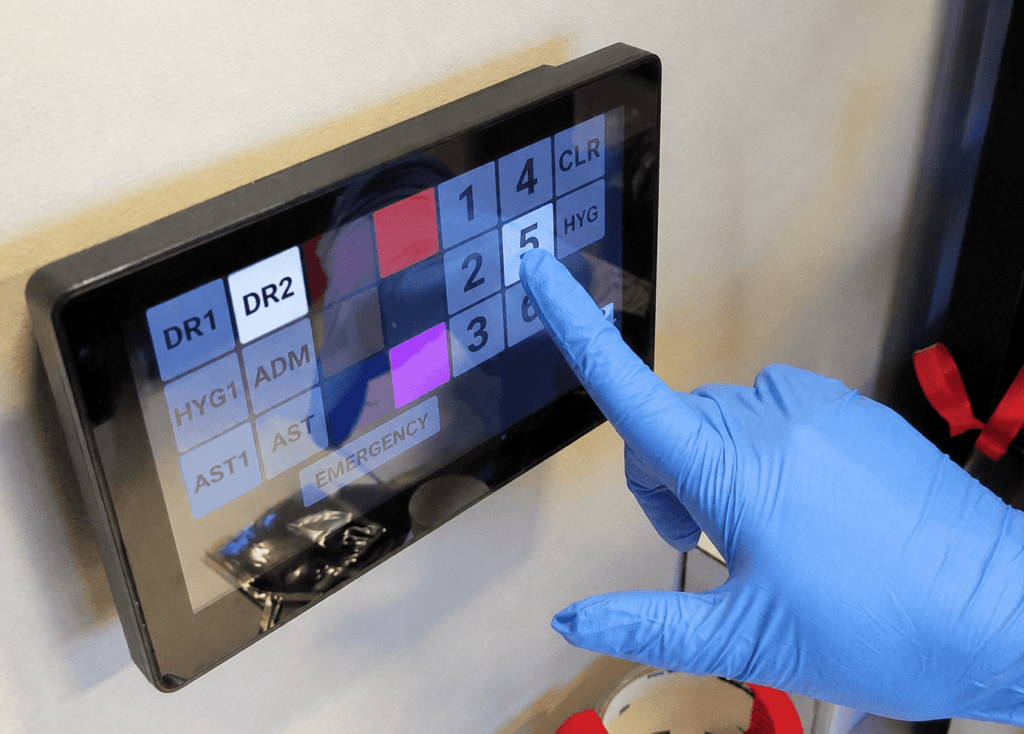 A person in blue gloves interacts with a touch screen, demonstrating a focus on hygiene and technology use.